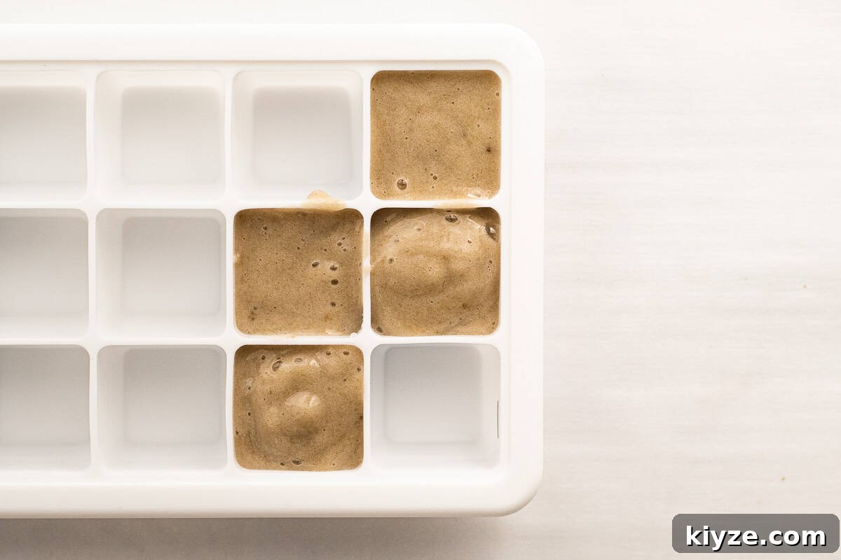 Quick 5-Minute Banana Puree Recipe for Babies 8 banana puree in a silicone ice cube tray