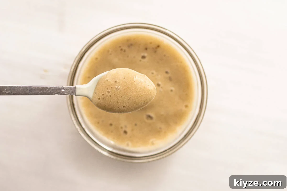 Quick 5-Minute Banana Puree Recipe for Babies 9 banana puree with a baby spoon