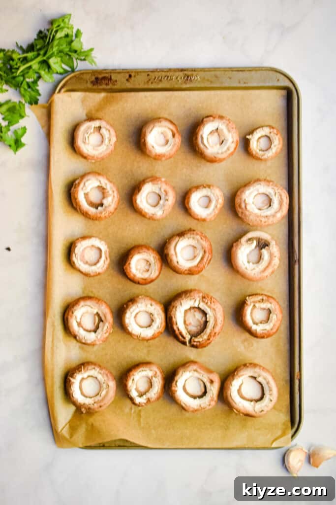 20 mushrooms are laid out on a sheet tray