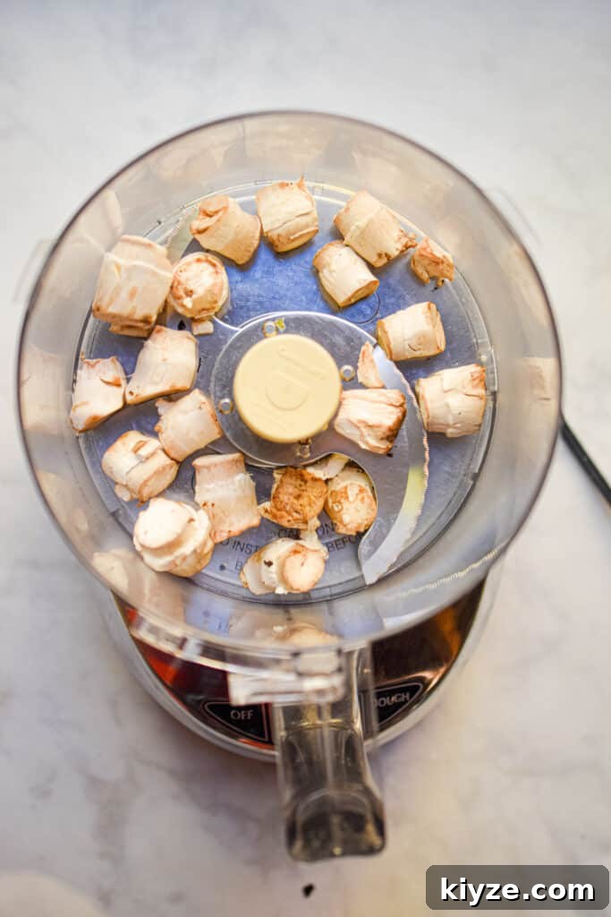 The mushroom caps are added to a food processor to make the stuffing for italian stuffed mushrooms