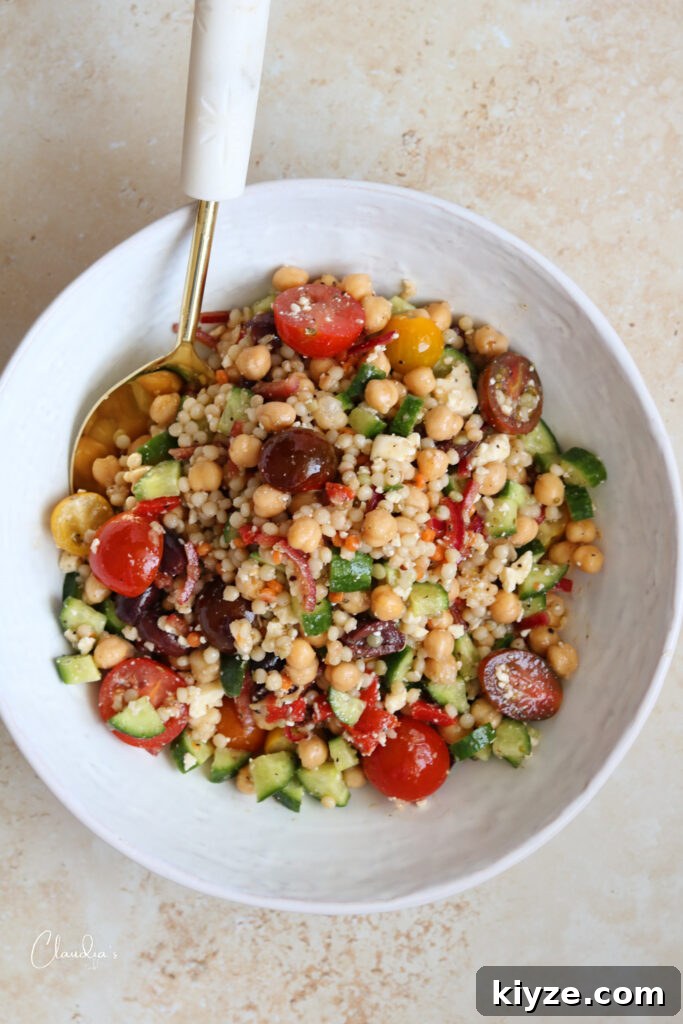 pearl couscous salad w feta chickpeas in white bowl top view 