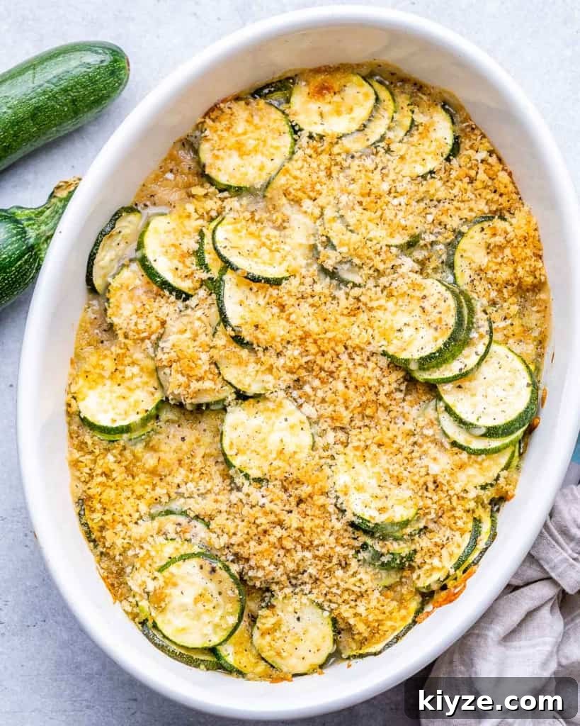 top view shot of zucchini casserole in a white dish