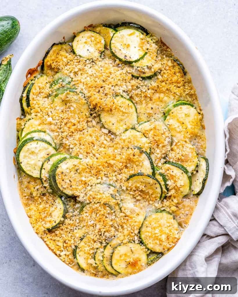 top view zucchini casserole baked in a white dish