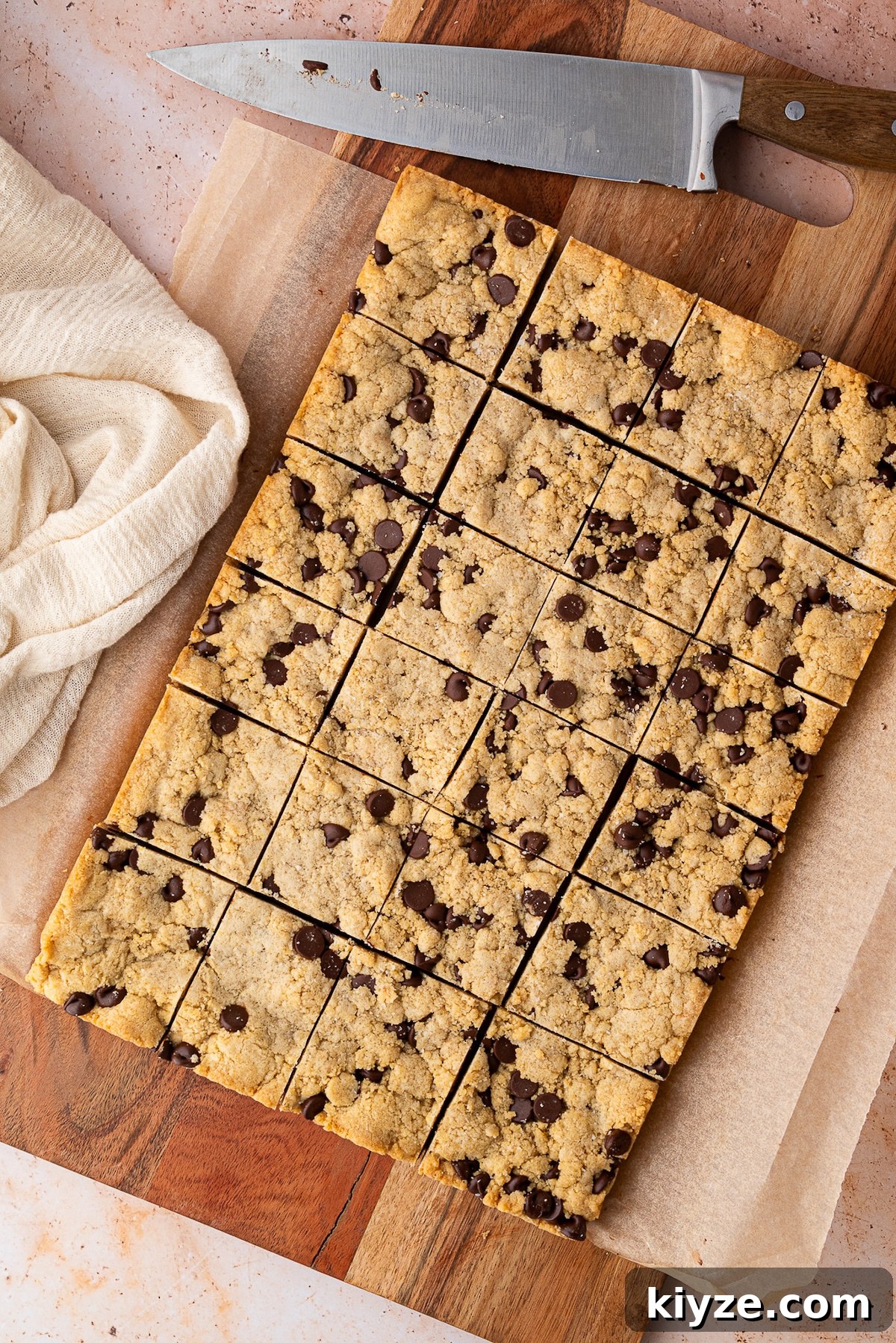 Bourbon Chocolate Chip Cookie Bars Recipe — Rich Boozy Dessert 2 Slicing the chocolate chip bars in 24 pieces.