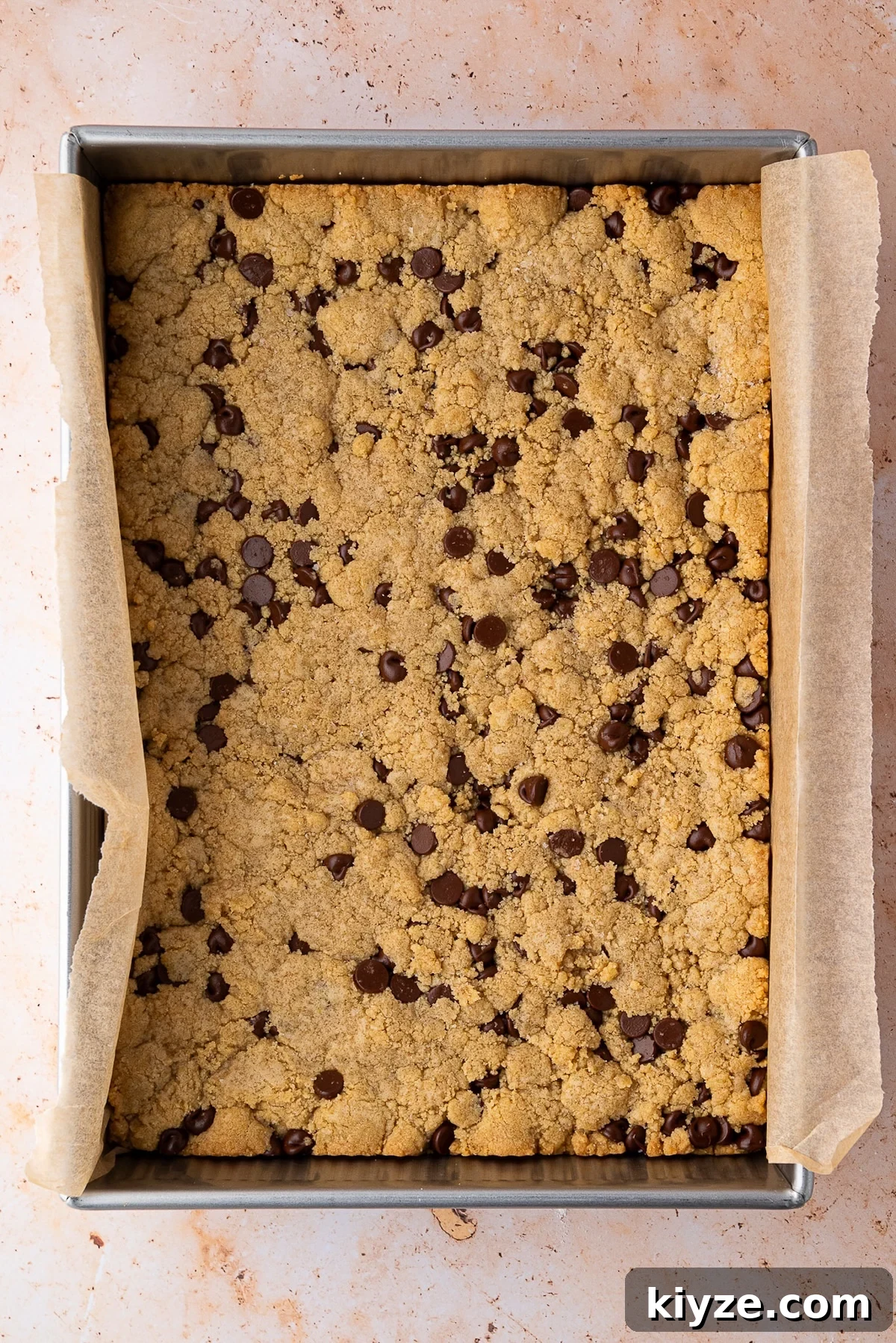 Bourbon Chocolate Chip Cookie Bars Recipe — Rich Boozy Dessert 9 Bourbon Chocolate Chip Cookies Bars just out of the oven with golden brown edges and lots of melty chocolate chips.
