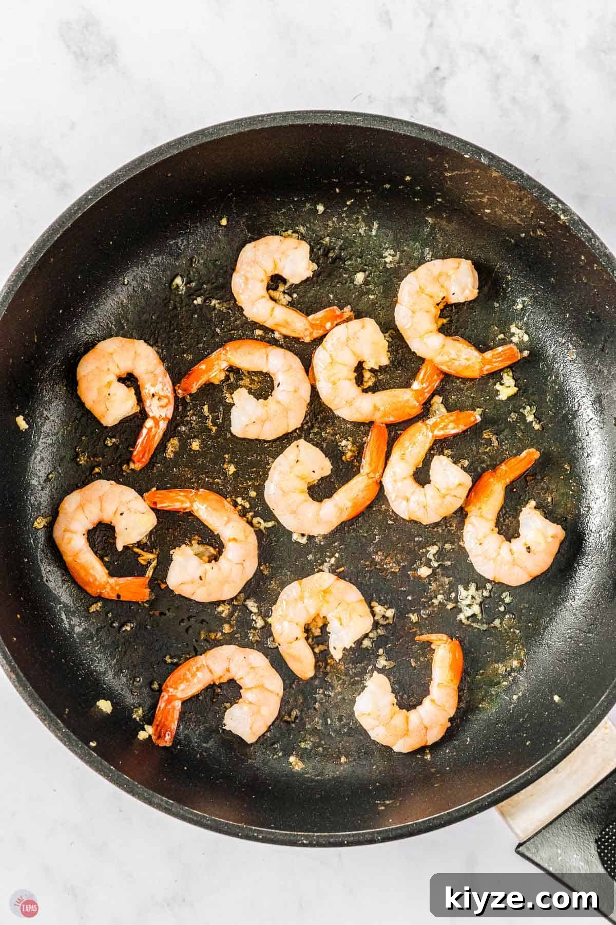 skillet with shrimp cooking