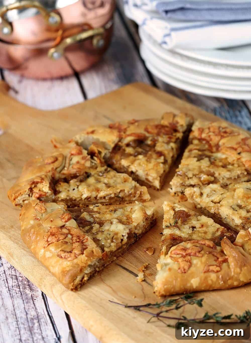 Instant Pot Caramelized Onions: Quick, Deeply Sweet Results 7 Caramelized French Onions baked into a delicious French Onion Gallette, served on a cutting board.