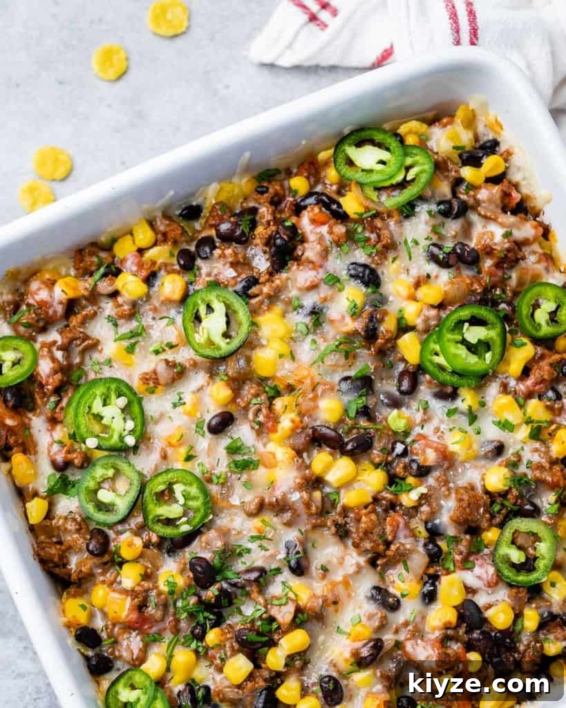 Cheesy Taco Casserole: One-Pan Mexican Dinner Recipe 11 Taco casserole in a white baking dish.