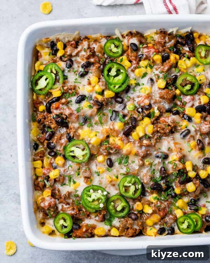 Cheesy Taco Casserole: One-Pan Mexican Dinner Recipe 9 Beefy casserole topped with cheese and sliced jalapeños.