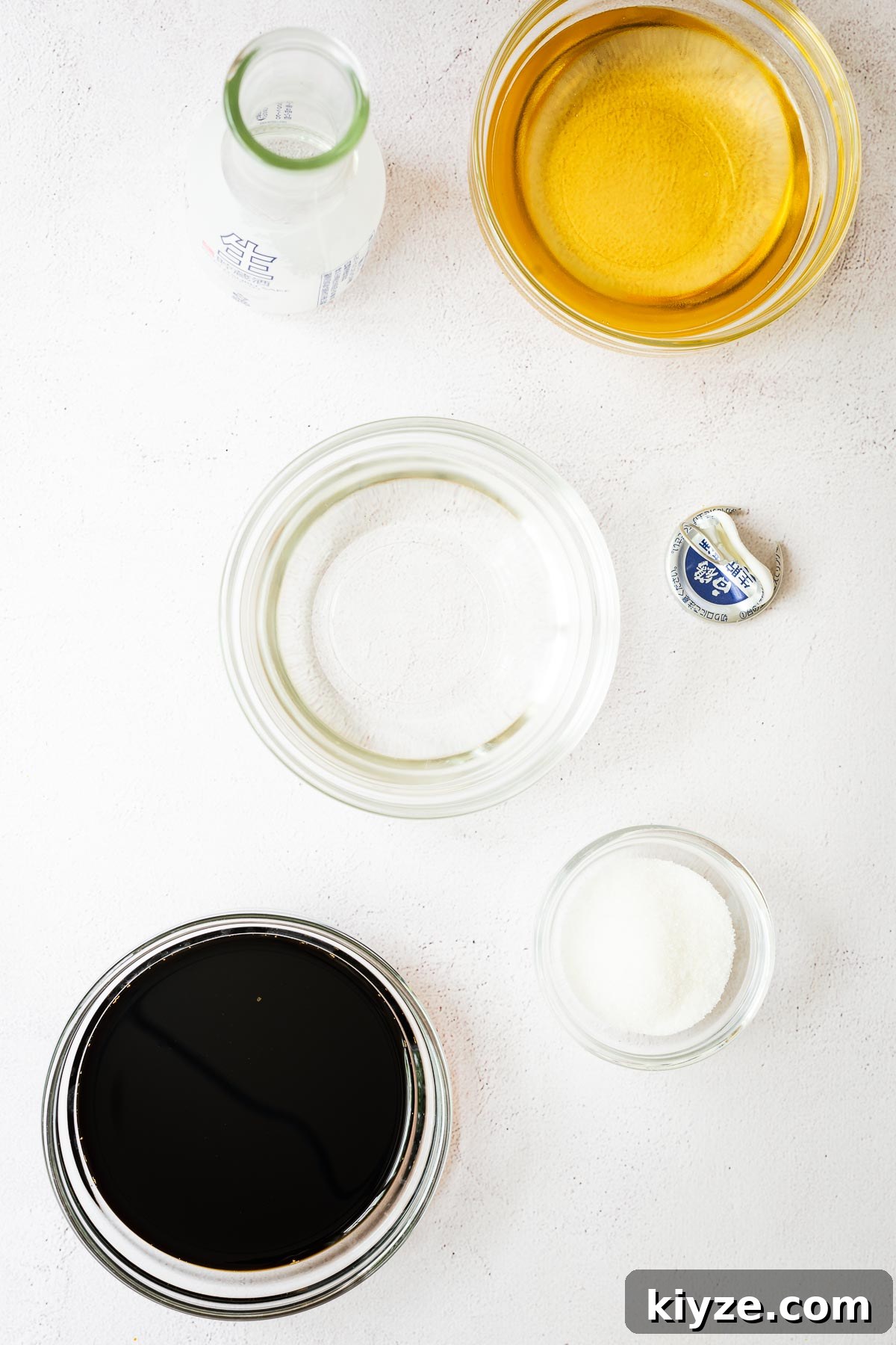 Sukiyaki sauce ingredients in glass bowls viewed from above.