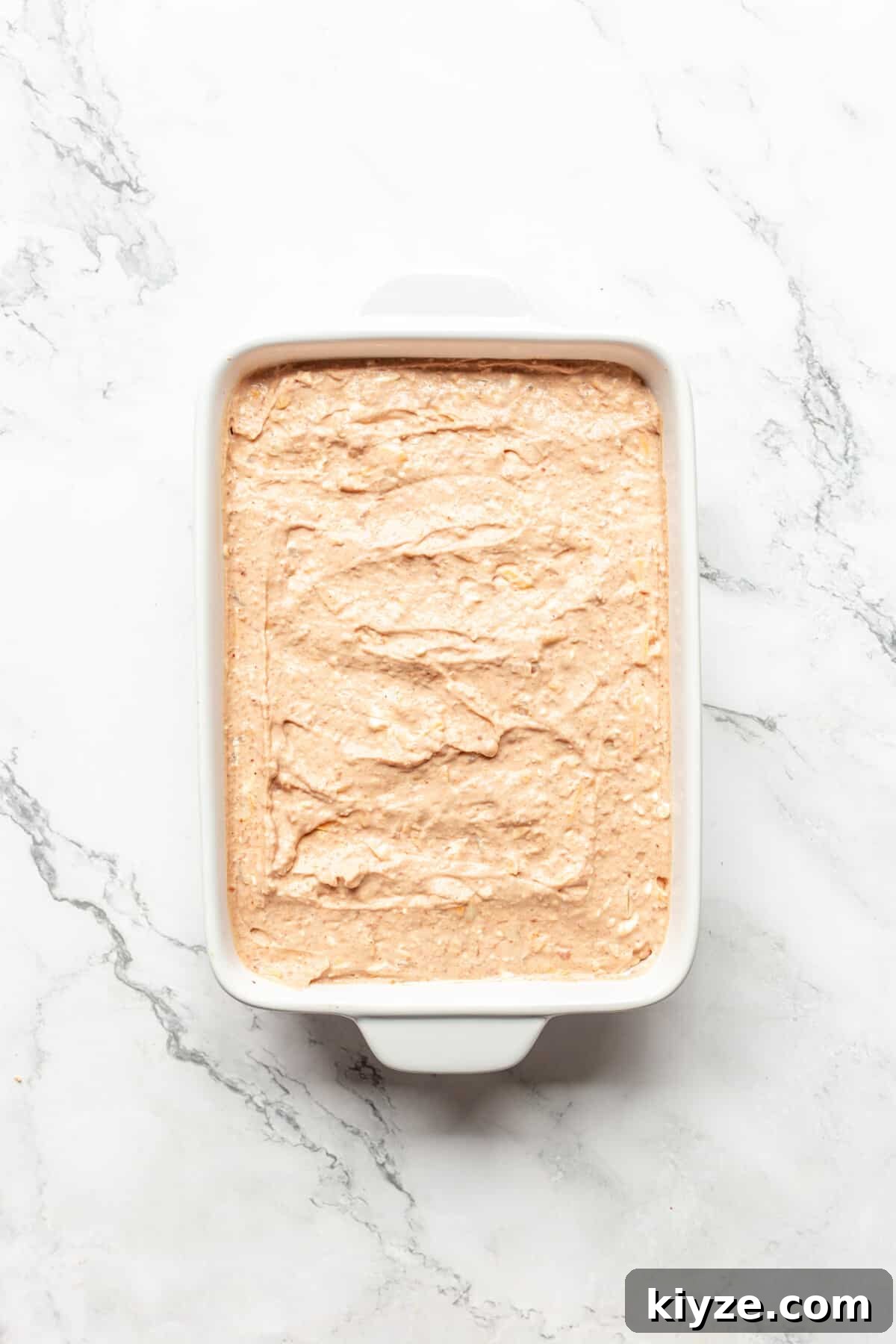 Creamy Cheesy Refried Bean Dip for Parties and Game Day 6 Refried bean dip with cream cheese in baking dish.