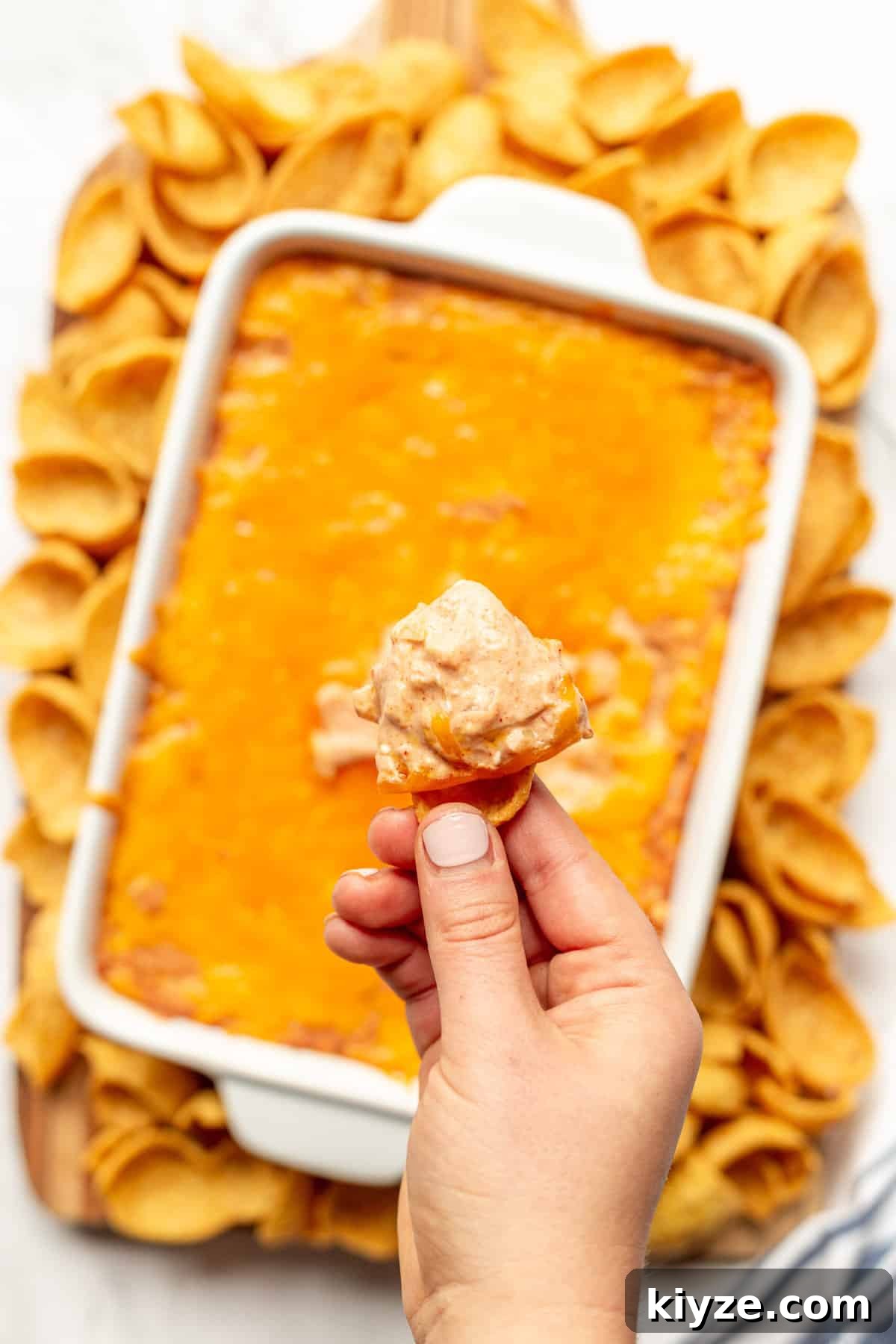 Creamy Cheesy Refried Bean Dip for Parties and Game Day 9 Frito chip with cheesy, creamy refried bean dip.