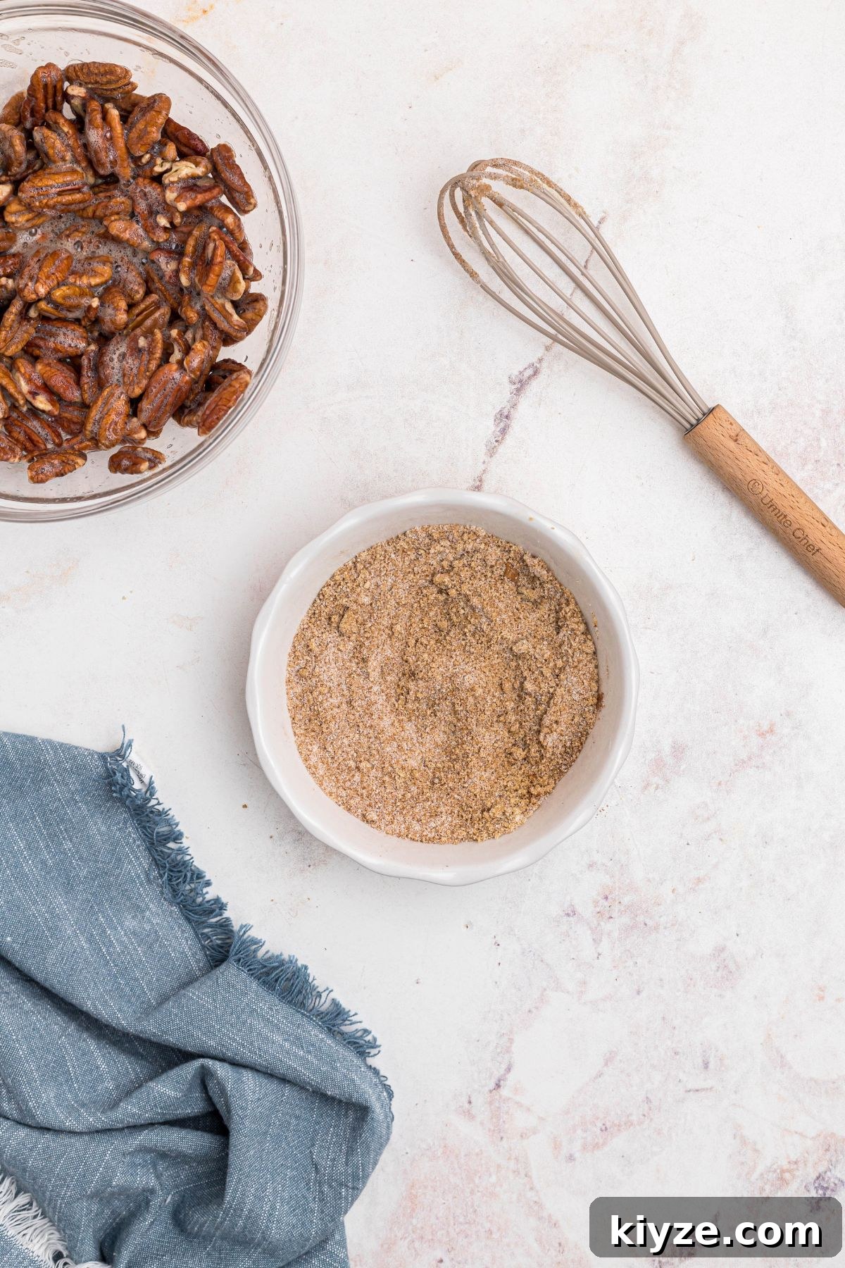 Cinnamon Sugar Candied Pecans Recipe for Snacking & Gifts 6 Sugars and other ingredients mixed in a small white bowl.