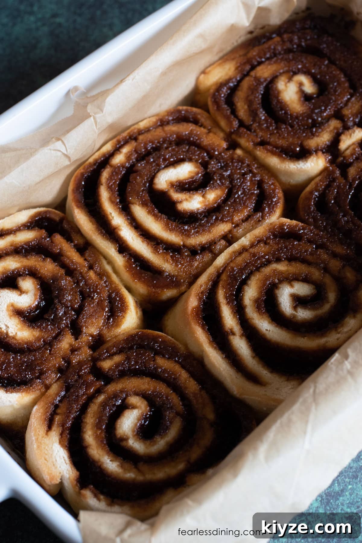 Gluten-Free Gingerbread Cinnamon Rolls Recipe 2 The baked gluten free gingerbread cinnamon rolls in a baking dish.