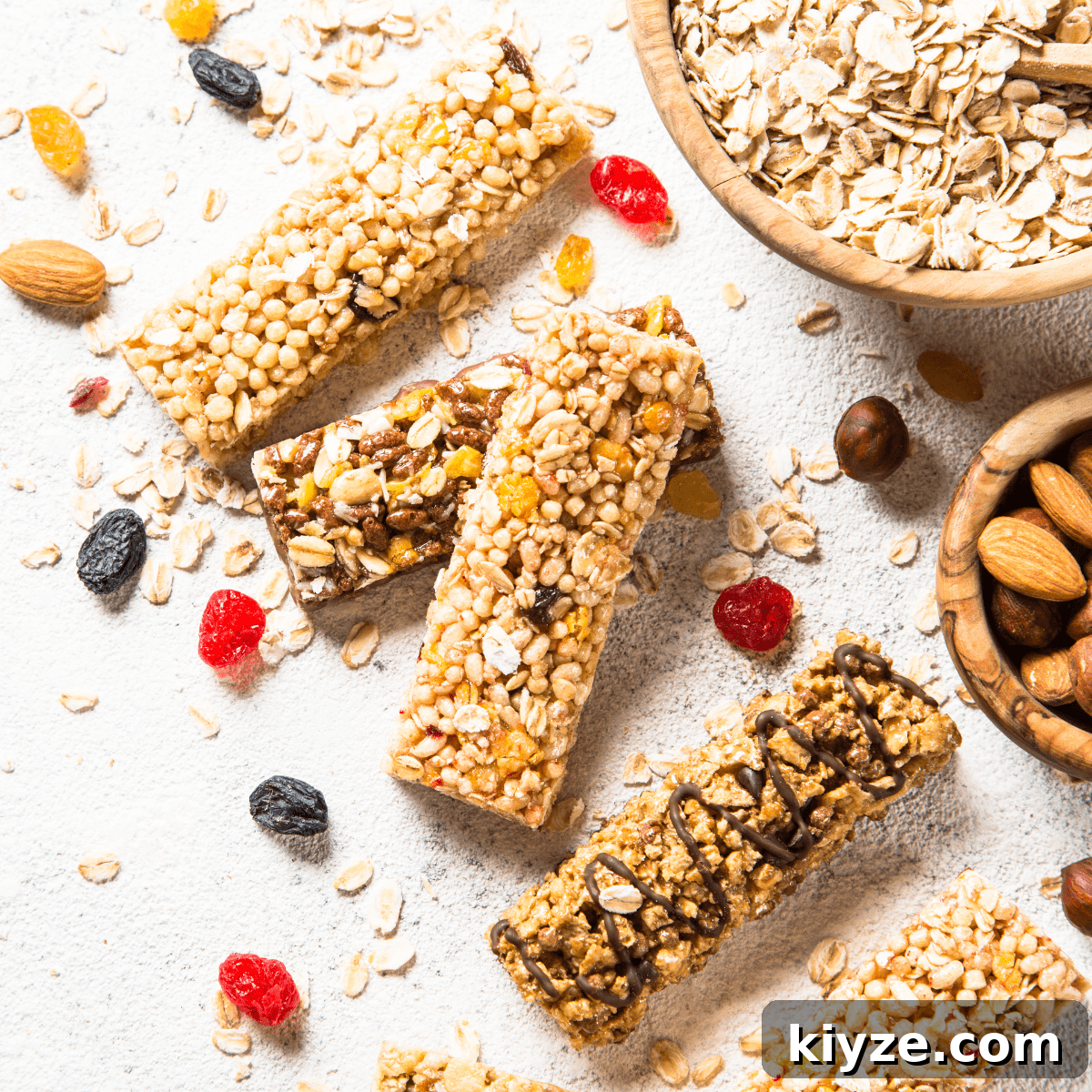 Prevent Toddler Grazing: Simple Strategies to Curb Constant Snacking 2 Five granola bars sitting on a table surrounded by ingredients, including nuts, oats, raisins and dried fruit