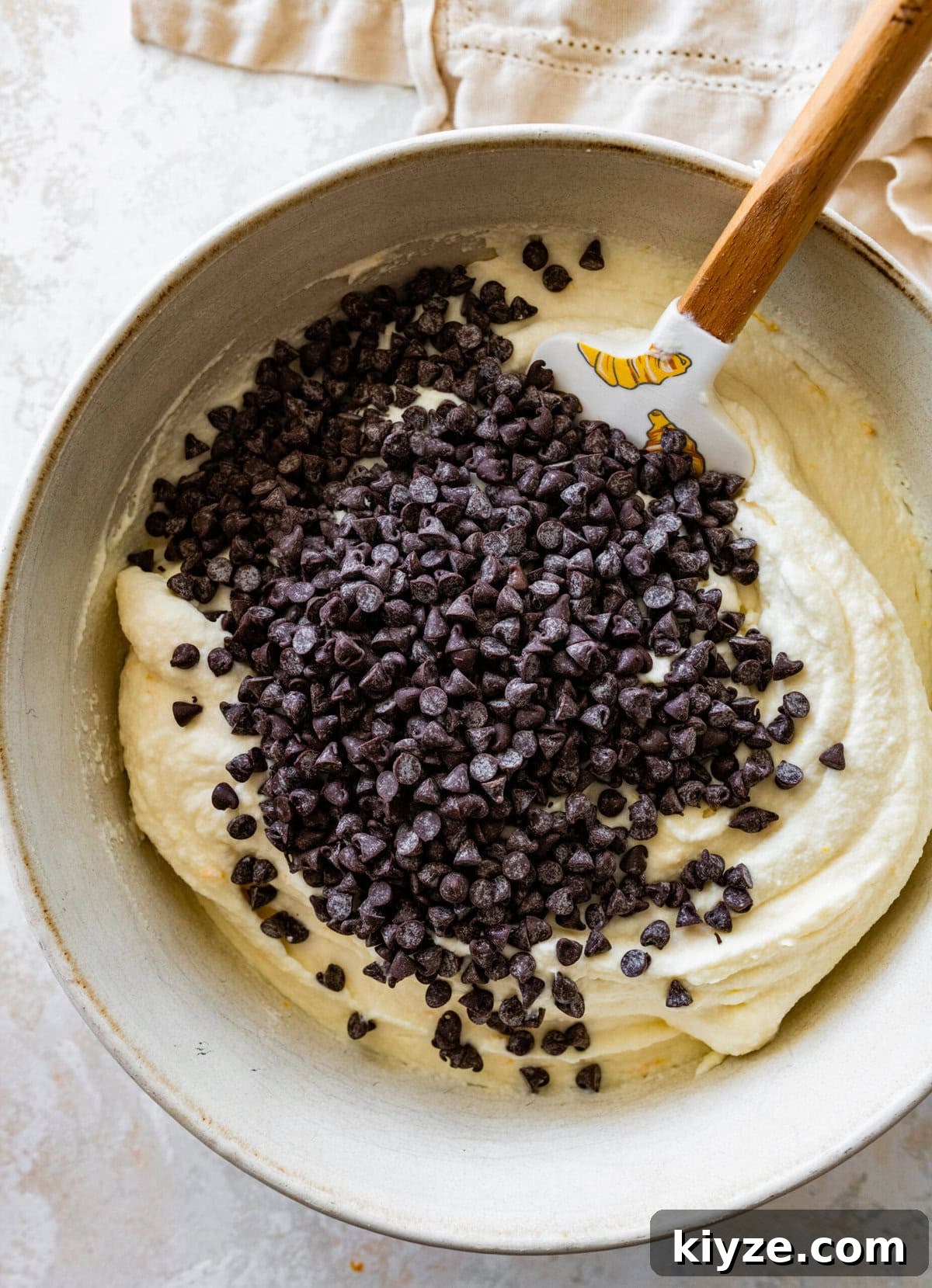 Italian Cannoli Cake Recipe: Classic Sicilian Dessert Guide 13 Chocolate chips in a bowl with cannoli frosting.
