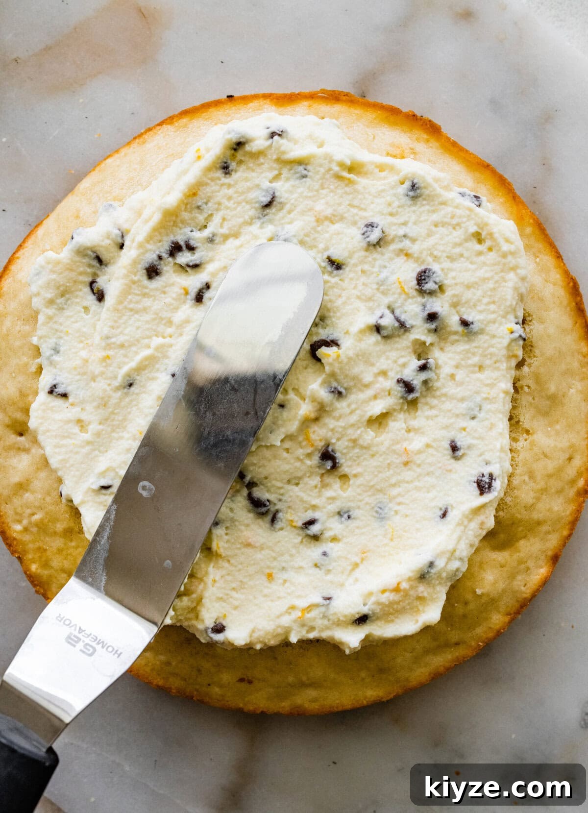 Italian Cannoli Cake Recipe: Classic Sicilian Dessert Guide 15 Spreading the cannoli filling in the layers of the cake.