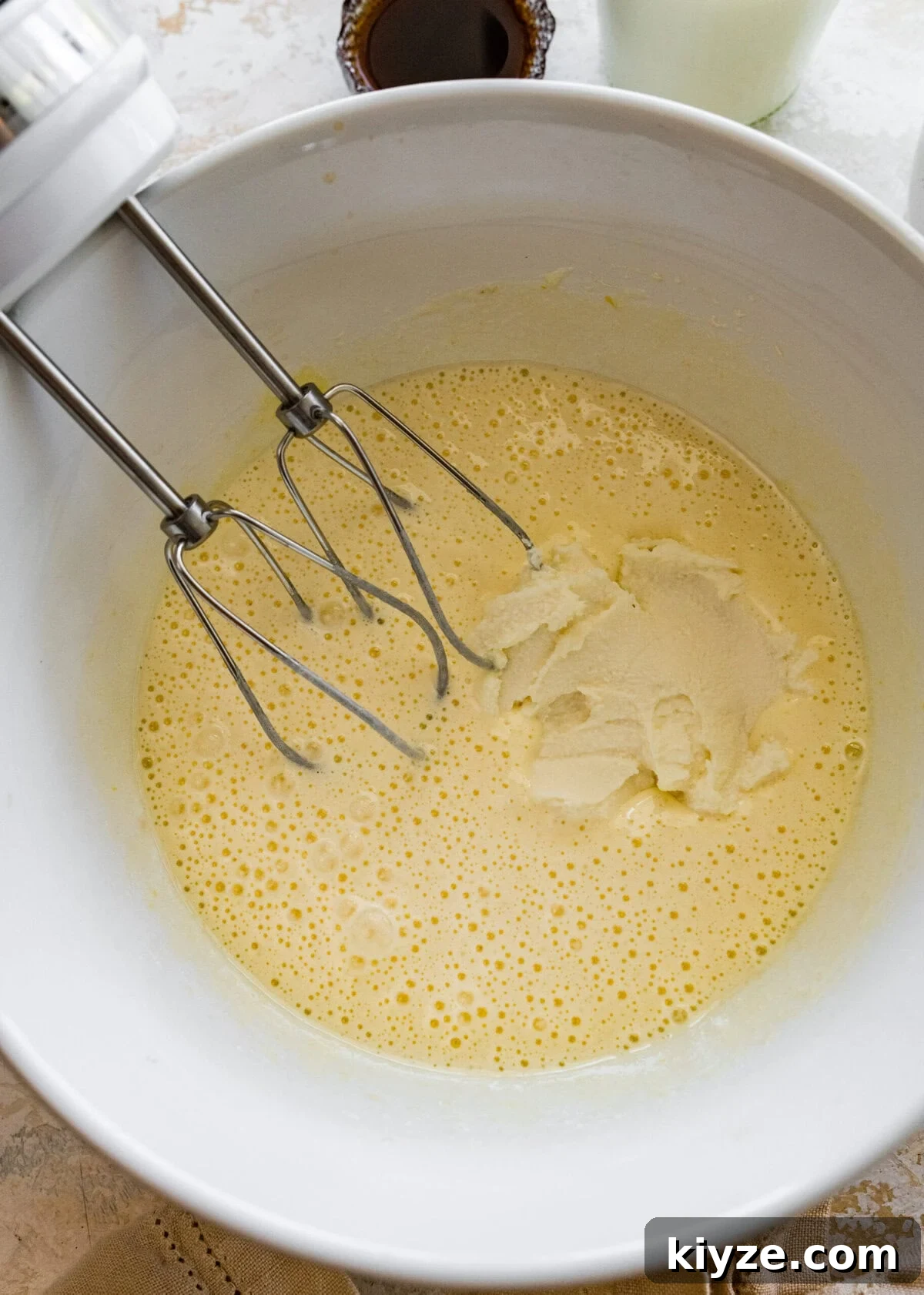 Italian Cannoli Cake Recipe: Classic Sicilian Dessert Guide 7 A bowl with a whisk in it to mix eggs and ricotta cheese.