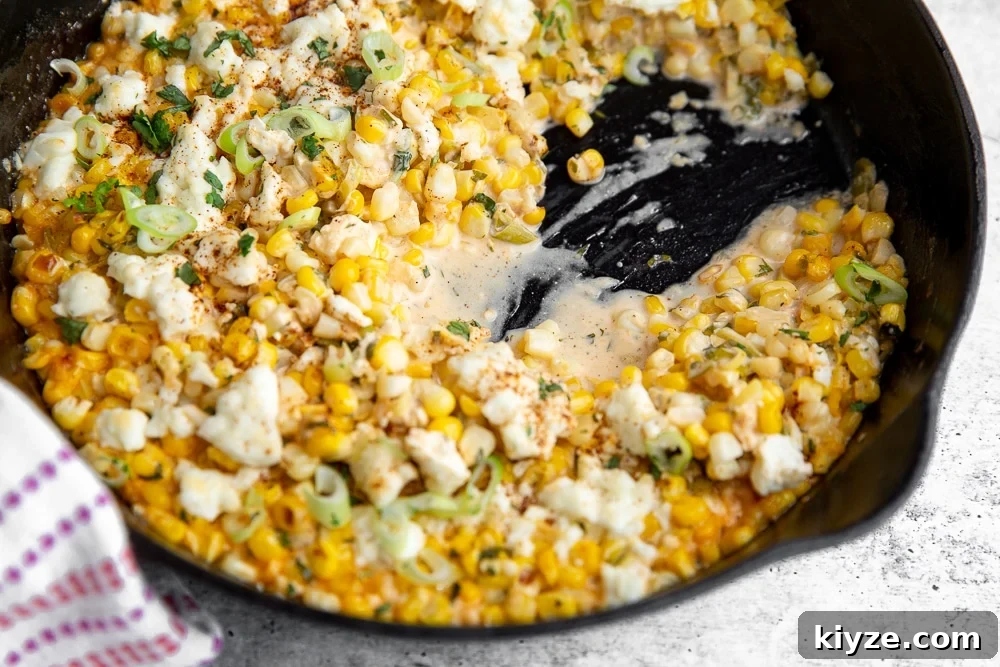 Jalapeño Feta Elote Dip Recipe for Parties and Game Day 4 Half eaten elote dip in cast iron skillet