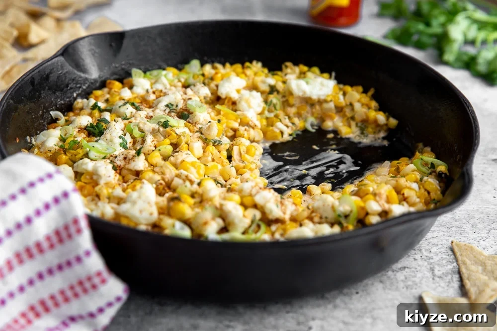 Jalapeño Feta Elote Dip Recipe for Parties and Game Day 7 Side angle shot of Mexican street corn dip in cast iron skillet.