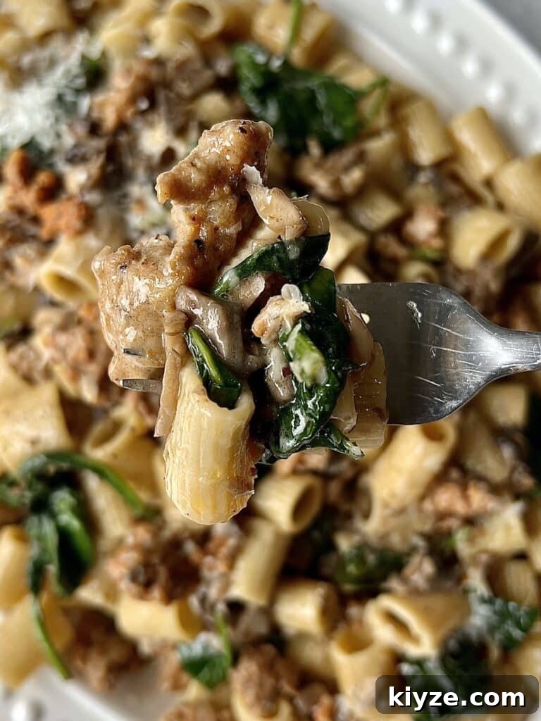 Creamy Pasta Norcina with Italian Sausage and Truffle Oil 8 Close up of norcina pasta on fork.
