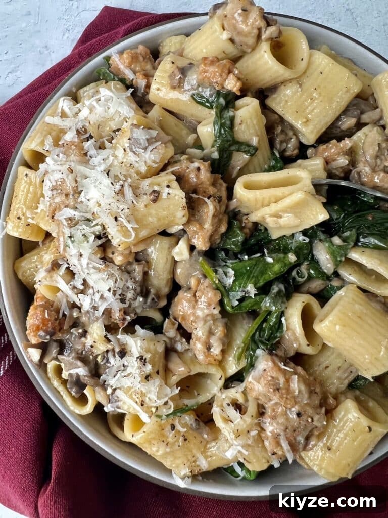Creamy Pasta Norcina with Italian Sausage and Truffle Oil 3 Norcina Pasta on pasta plate with grated cheese and fork.