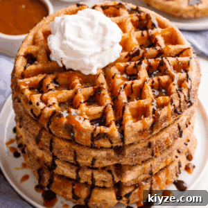 A stack of churro waffles topped with whipped cream and chocolate sauce.