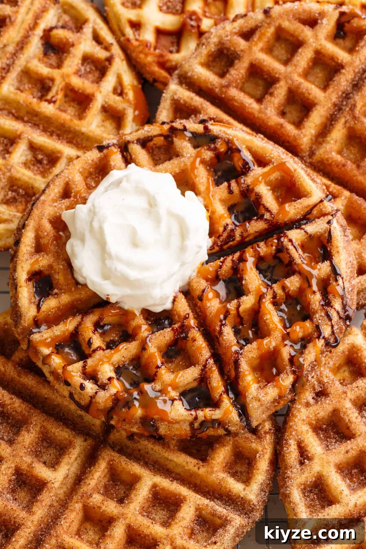 Crispy Cinnamon Churro Waffles Recipe 3 close up image of several churro waffles stacked on one another.