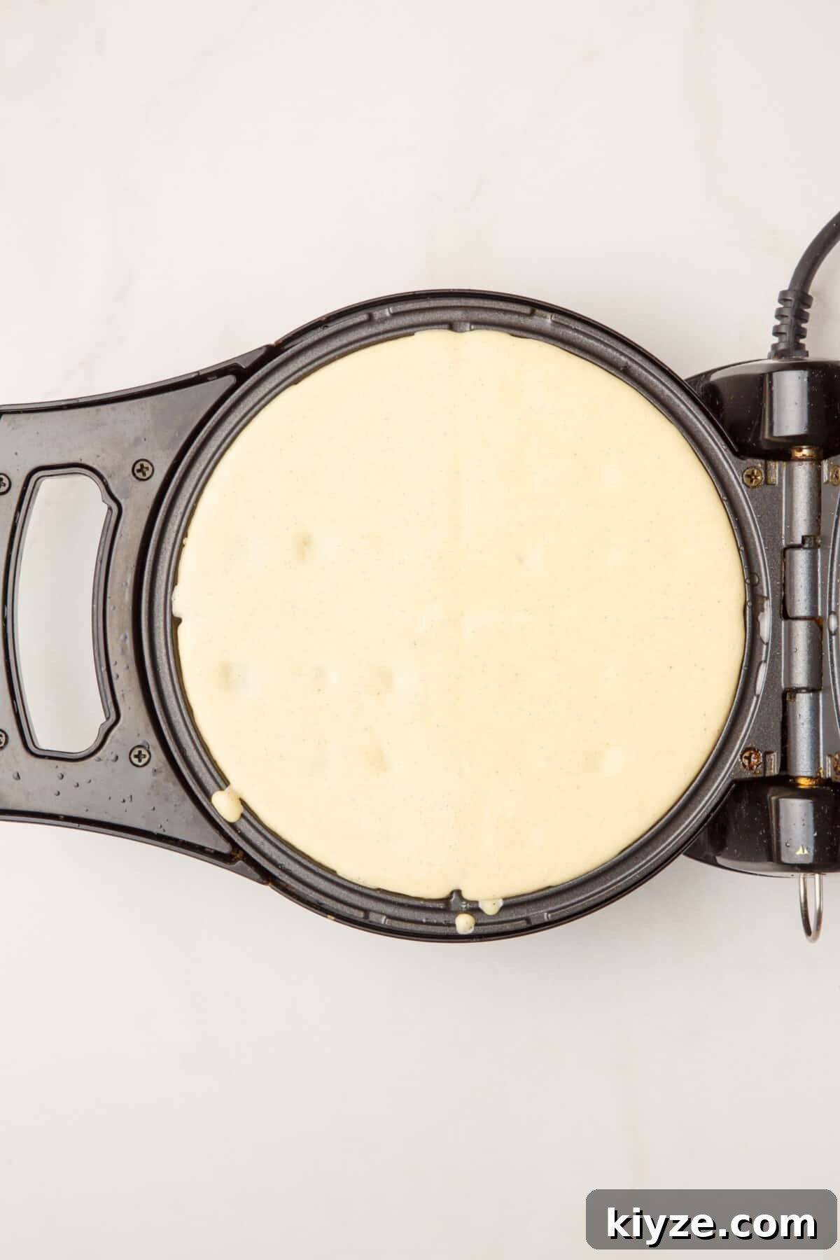 waffles batter on a waffle iron.