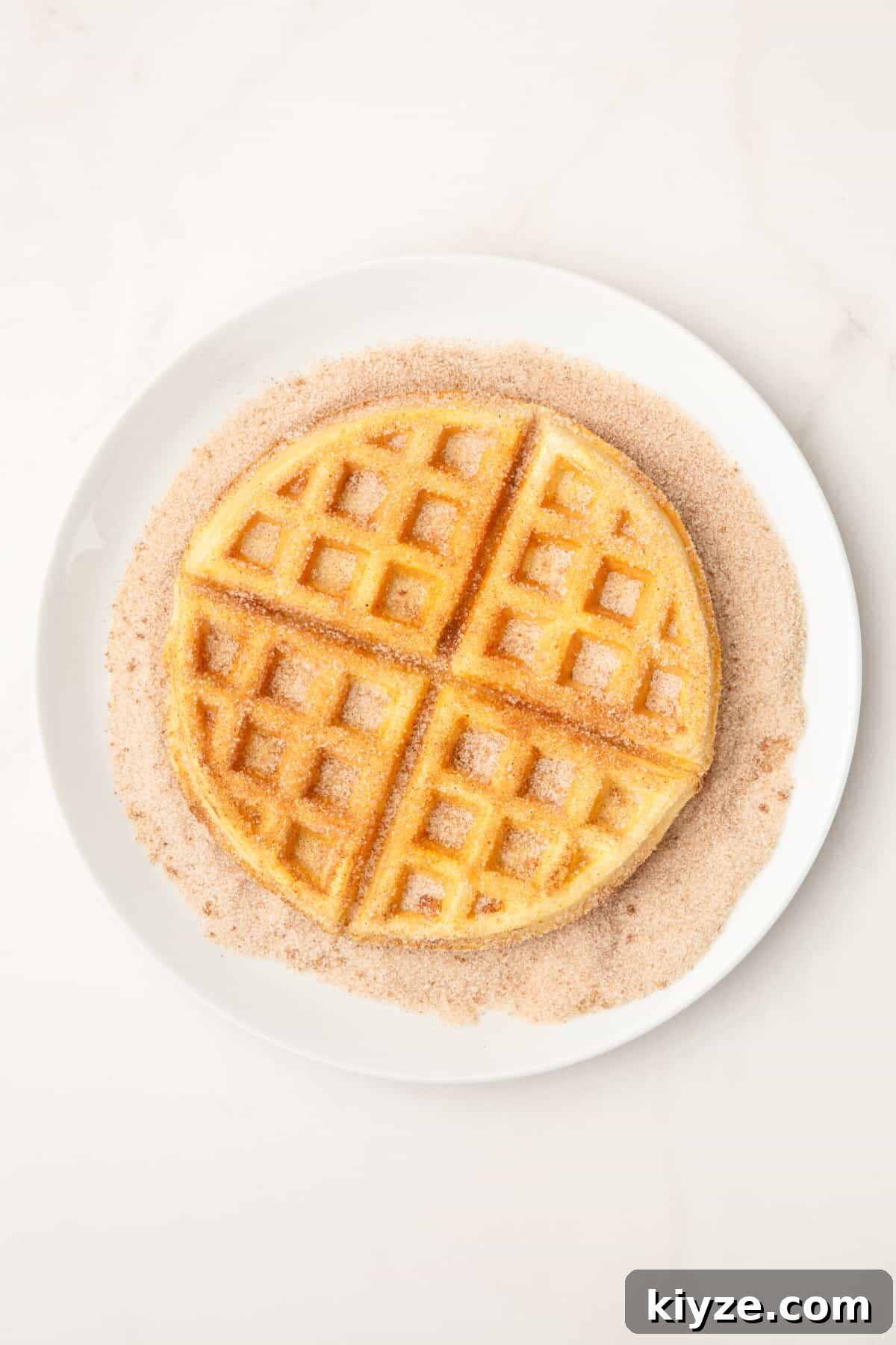 Crispy Cinnamon Churro Waffles Recipe 8 waffle coating in cinnamon sugar.
