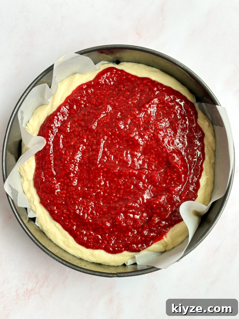 Almond Raspberry Layer Cake with Fresh Raspberry Glaze 9 raspberry compote layer.