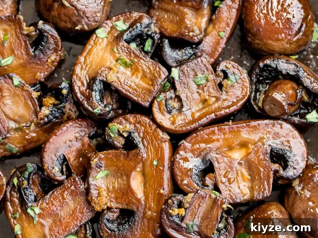 Garlic Butter Sautéed Mushrooms Recipe — Quick Flavorful Side 13 close up of twice cooked mushrooms with garlic butter and chopped parsley
