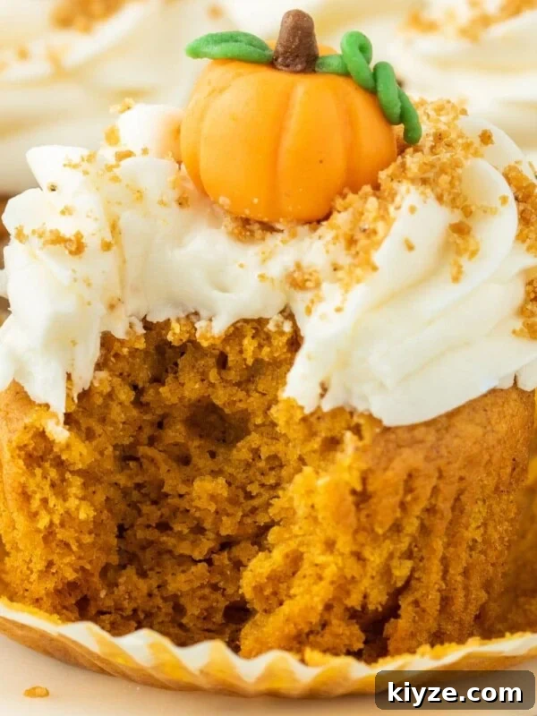 pumpkin cupcake iced with cream cheese frosting