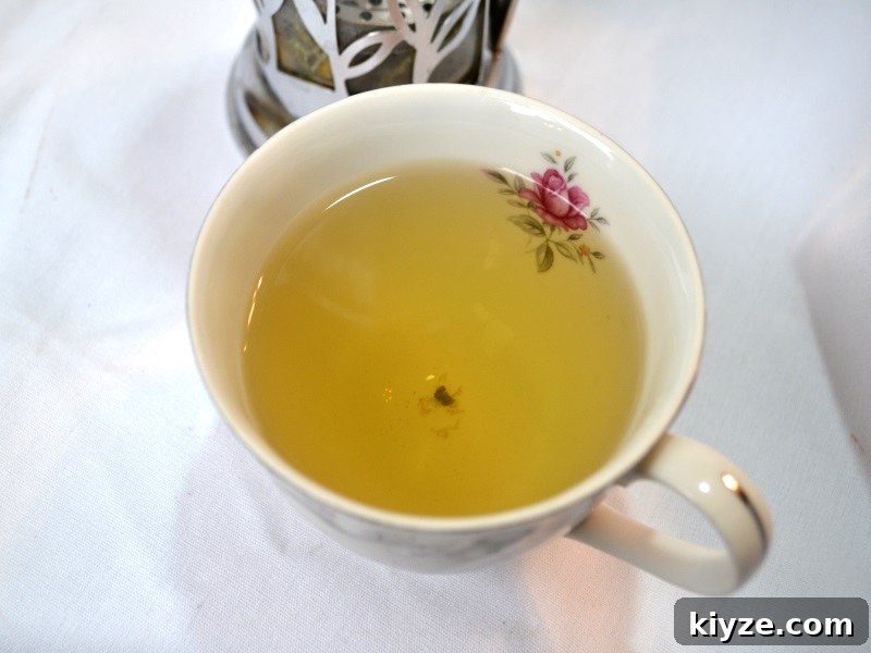 Lavender and Chamomile Tea: Calm Your Mind with Soothing Herbal Blend 2 Lavender Chamomile Tea in tea cup with rose from www.ApronFreeCooking.com