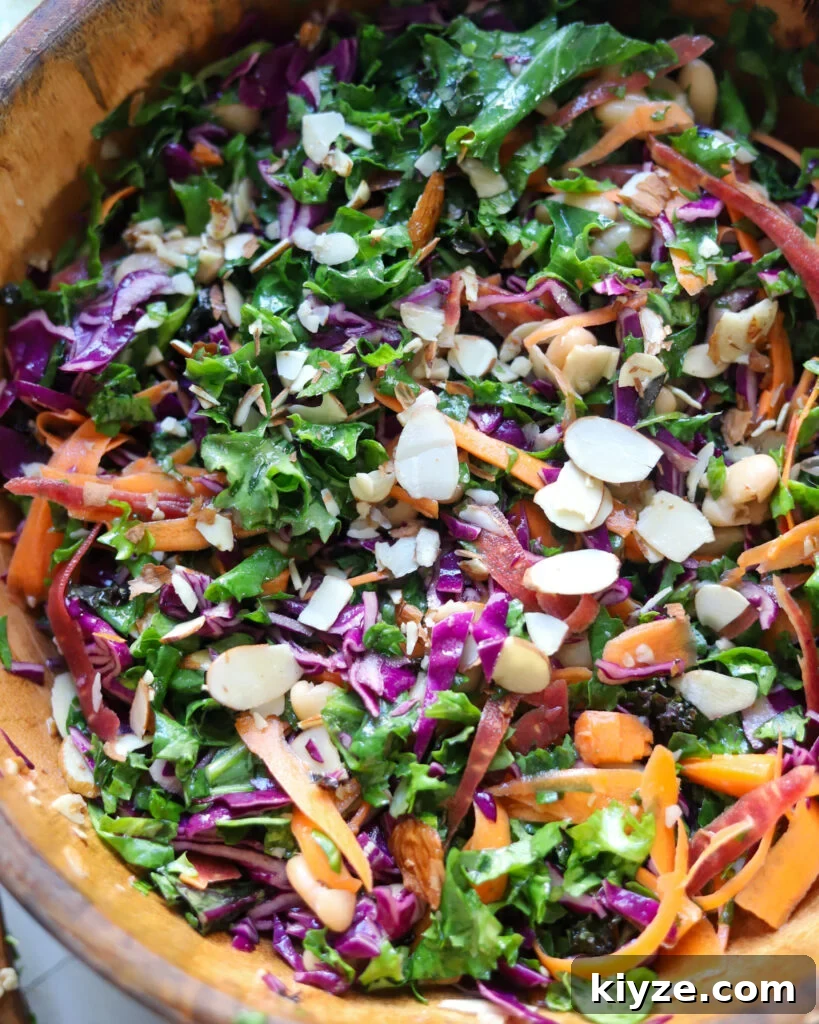 18 Flavorful Vegan Bean Salad Recipes for Every Occasion 15 the best kale crunch salad with almonds and carrots in a wooden serving bowl.