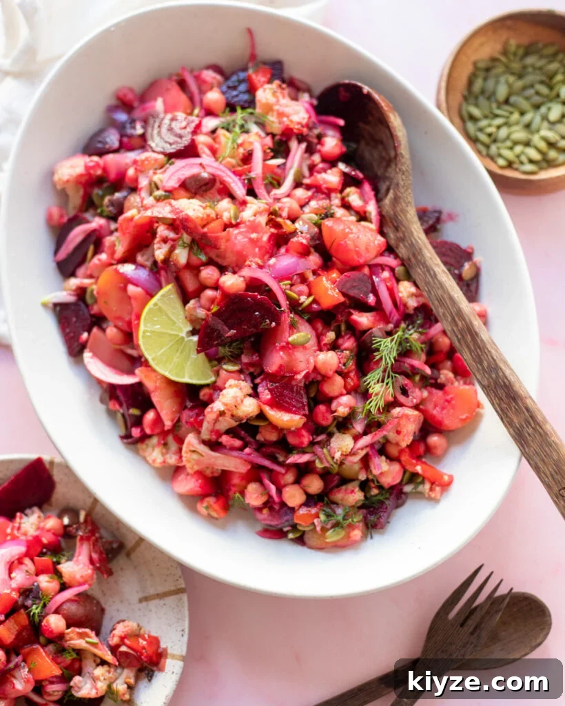 18 Flavorful Vegan Bean Salad Recipes for Every Occasion 18 image pretty beet & potato salad on a white serving platter with wooden utensils.
