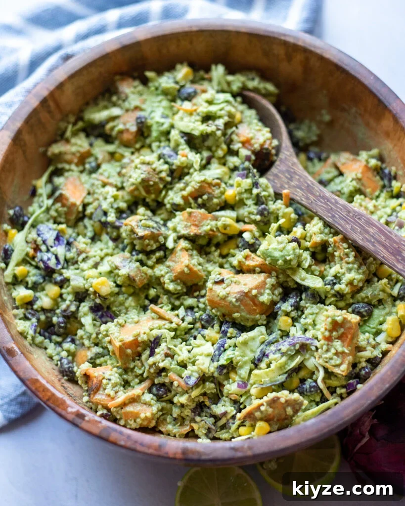 18 Flavorful Vegan Bean Salad Recipes for Every Occasion 7 Southwest Quinoa bean salad in a wooden serving bowl with a spoon.