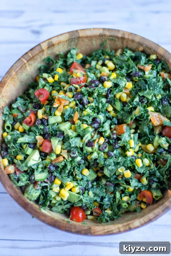 18 Flavorful Vegan Bean Salad Recipes for Every Occasion 9 image kale and bean salad in a wooden serving bowl.