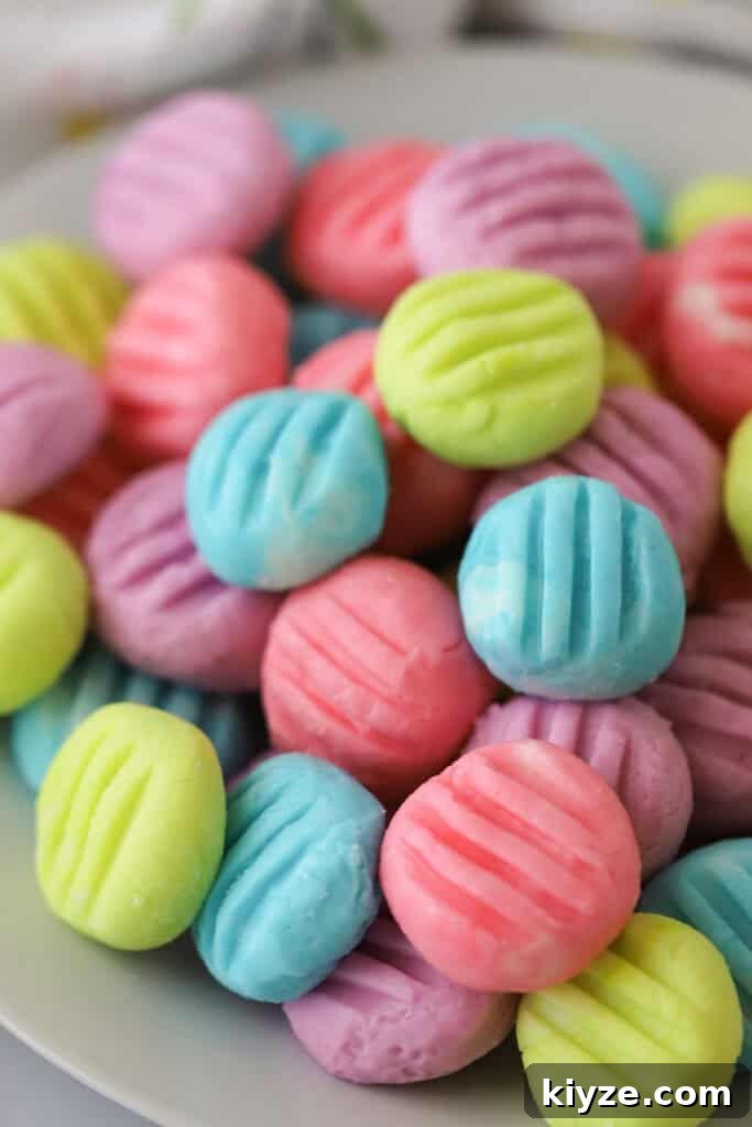 Cream Cheese Mint Candies Recipe: Soft Homemade Mints in Minutes 2 A bowl full of colorful cream cheese mint candies that have been pressed lightly with a fork to make a little mark on top.