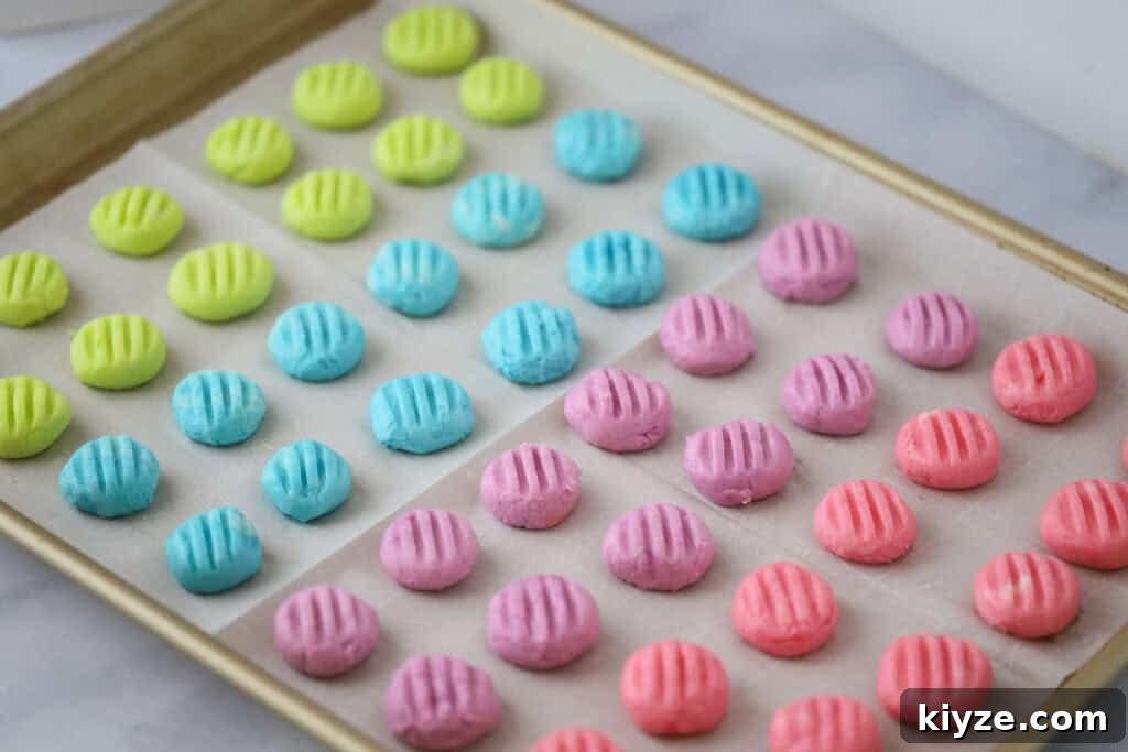 Cream Cheese Mint Candies Recipe: Soft Homemade Mints in Minutes 4 A baking sheet covered with parchment paper with rows of cream cheese peppermint candies drying.