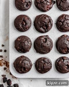 completed Blackberry Chocolate Cupcakes without icing on top in muffin tin