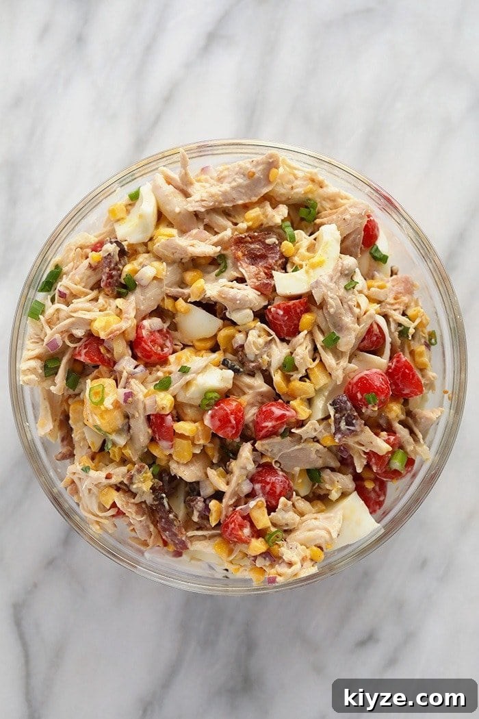 Your lunch for the week is ready in less than 30 minutes with this protein-packed Rotisserie Chicken Cobb Salad! rotisserie chicken cobb salad in a bowl ready to be served