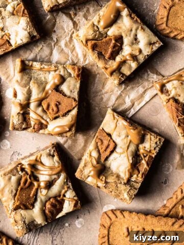 Cookie butter squares on brown parchment paper.