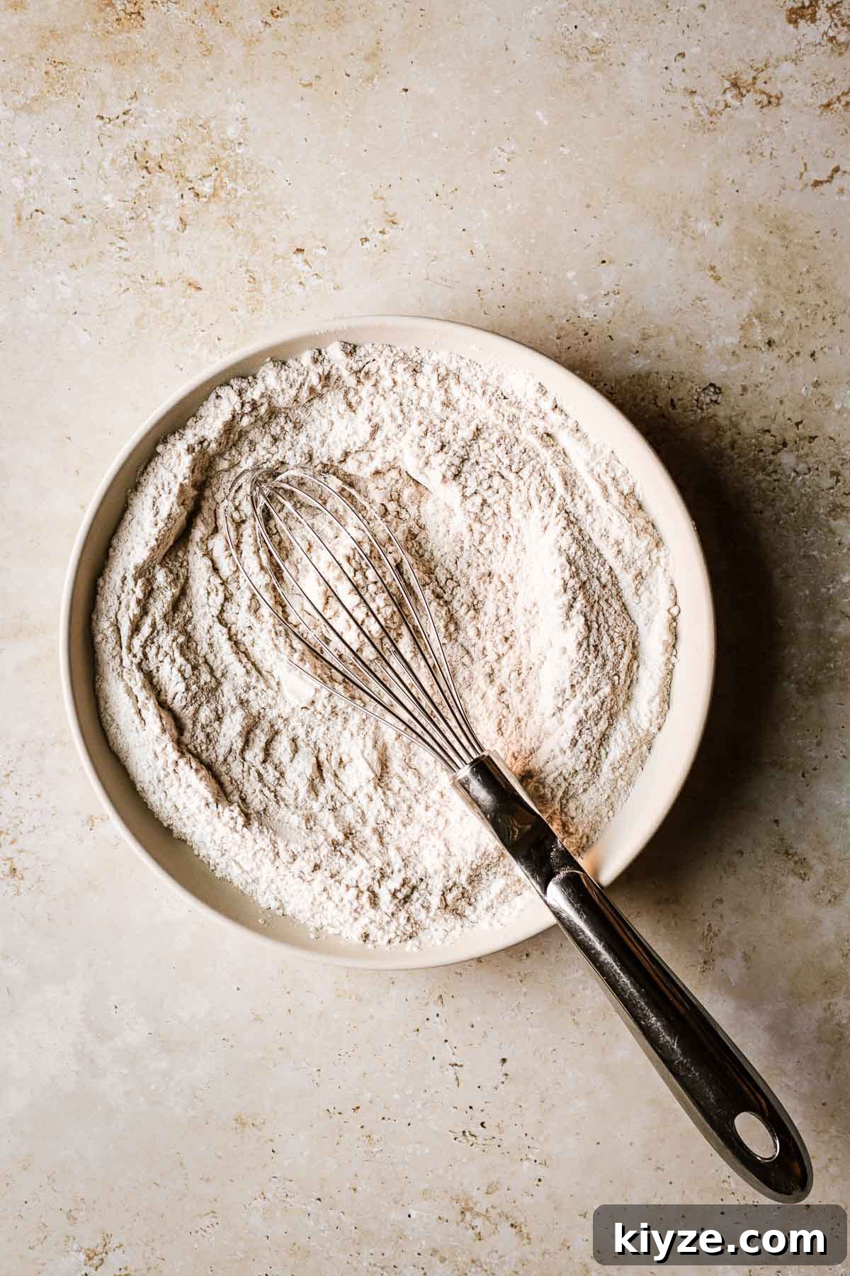 Cinnamon Streusel Muffins Recipe with Crunchy Brown Sugar Topping 6 A shallow tan bowl filled with whisked dry ingredients.