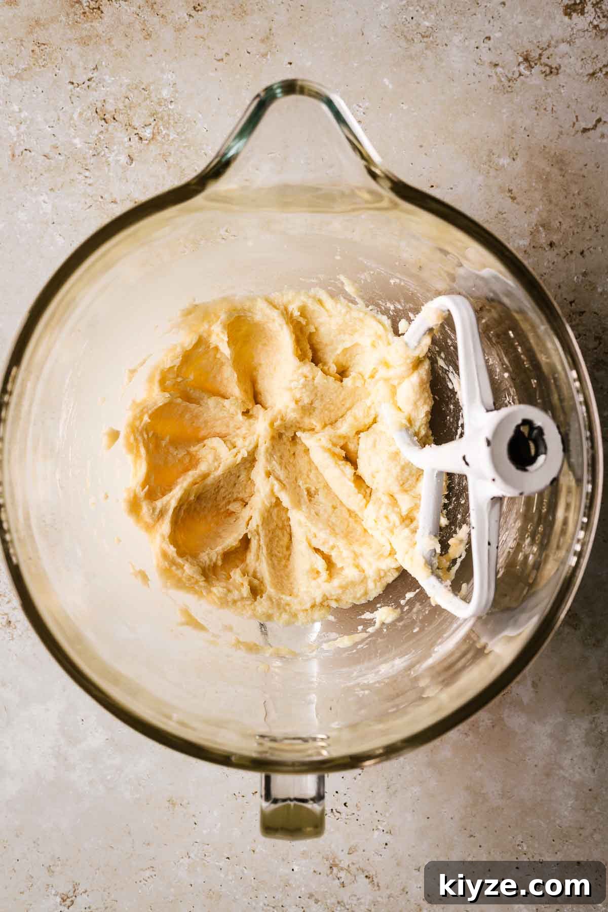 Cinnamon Streusel Muffins Recipe with Crunchy Brown Sugar Topping 8 A mixing bowl with creamed butter and sugar with egg and vanilla added.