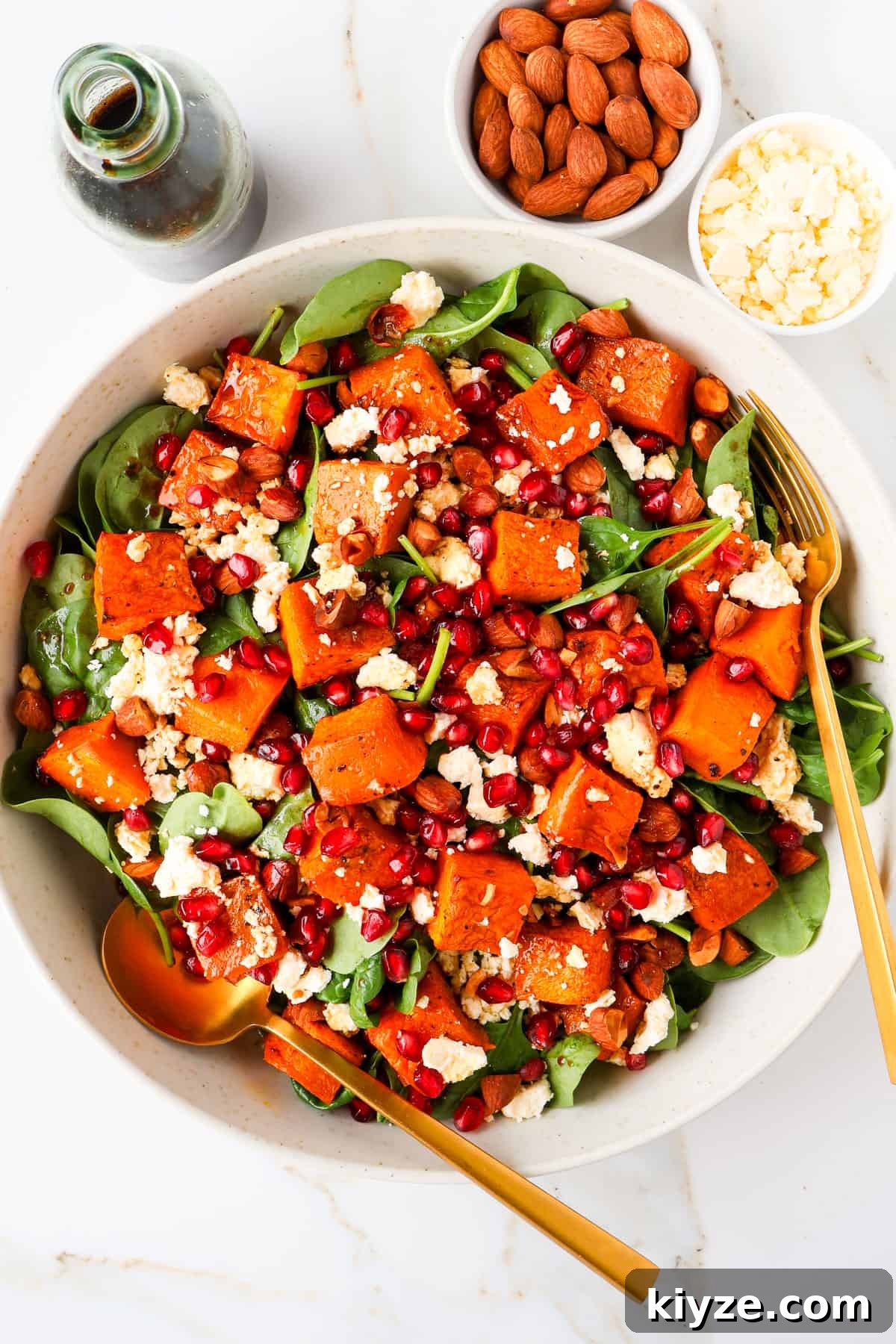 Roasted Pumpkin, Spinach and Feta Salad with Maple Vinaigrette 2 Pumpkin salad in a bowl with gold cutlery.