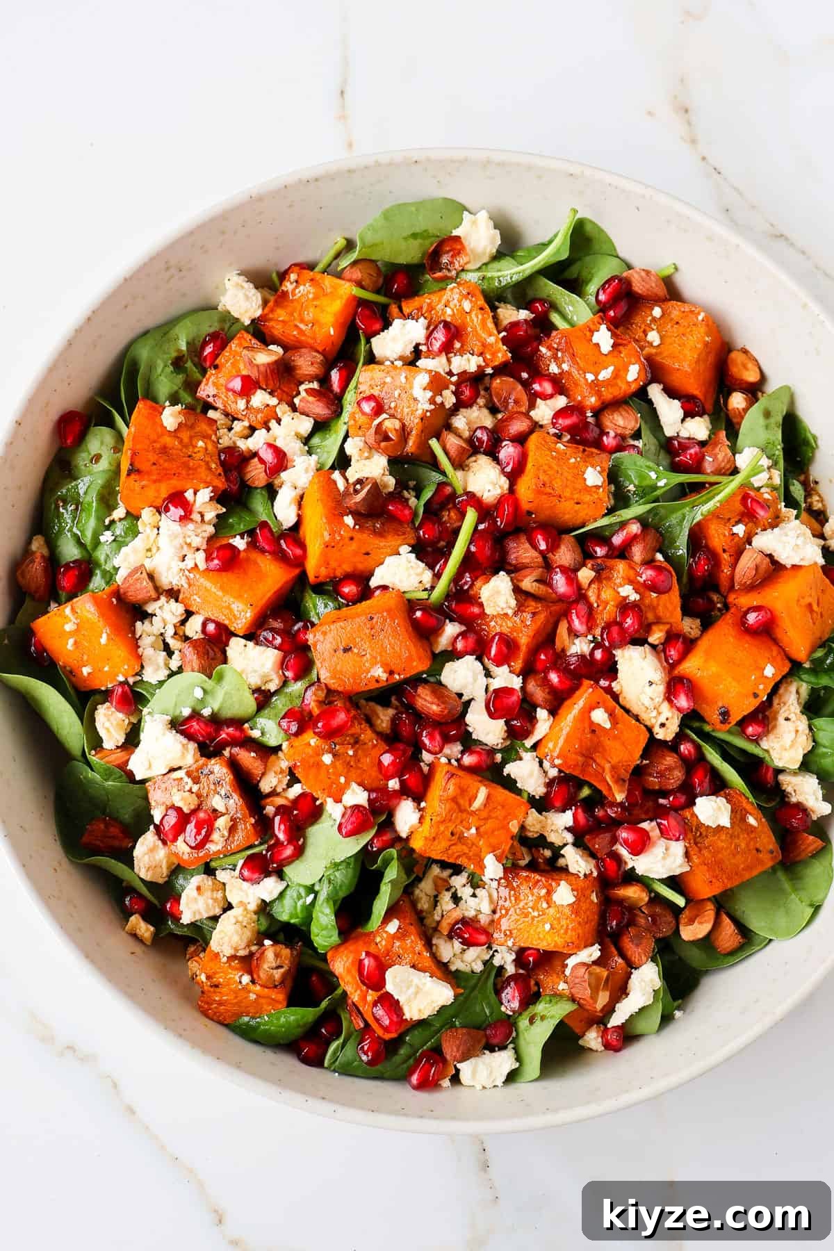 Roasted Pumpkin, Spinach and Feta Salad with Maple Vinaigrette 3 Close up shot of salad in a bowl.