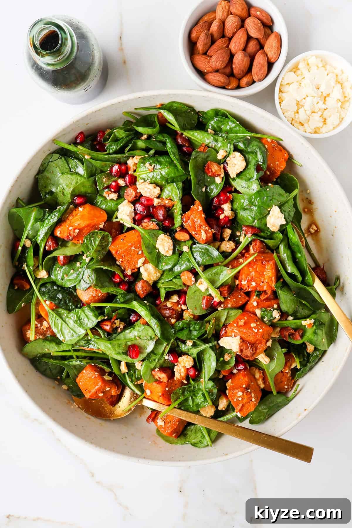 Roasted Pumpkin, Spinach and Feta Salad with Maple Vinaigrette 7 Tossed pumpkin salad in a bowl.