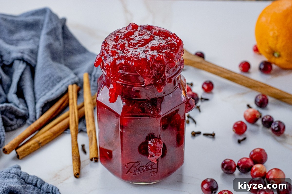 Tangy Cranberry Orange Sauce Recipe for Holiday Feasts 5 jar filled to spilling over with cranberry orange sauce