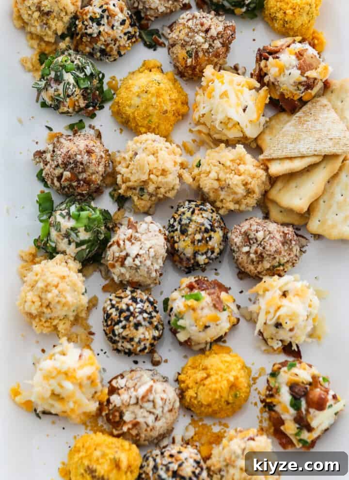 A white platter filled with cheese truffles (mini cheese balls) with crackers and pretzels at a party.
